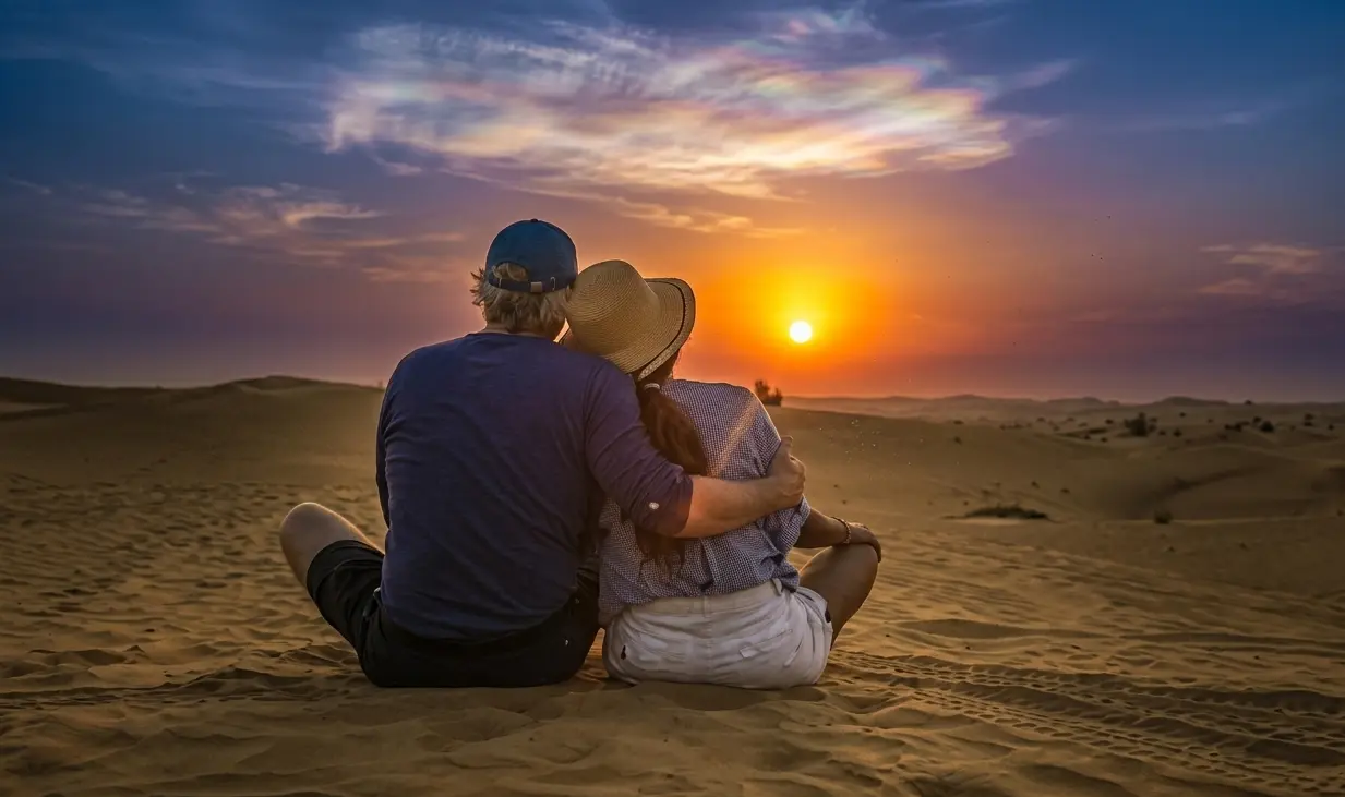Couple enjoying sunset view at desert safari