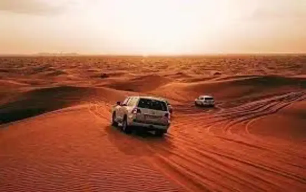 Dubai desert safari vehicles dune bashing with safety gear and tourists following safety rules