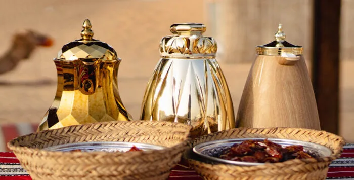 Arabian coffee served in a Bedouin-style desert safari camp in Dubai at sunset