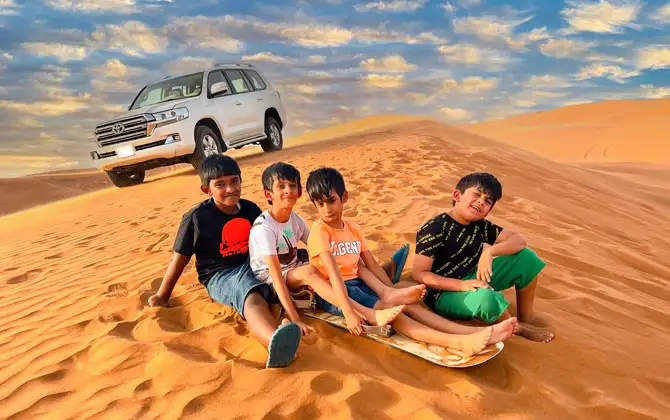 Tourists enjoying a safe desert safari camping experience in Dubai at sunset