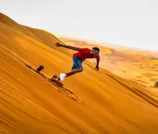 Tourist enjoying desert safari in Dubai with dune bashing and camel ride