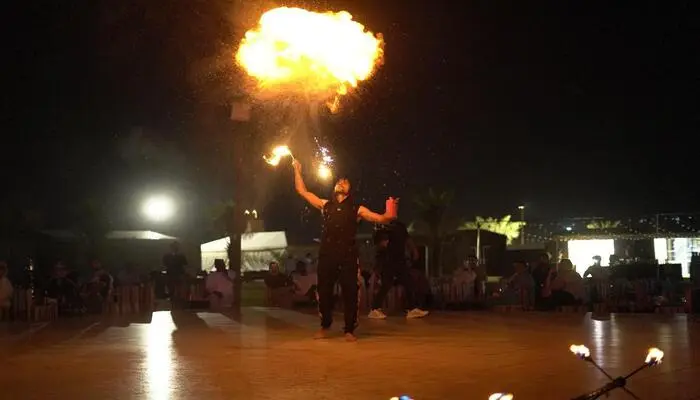 Tourists enjoying desert safari Dubai trending activities with dune bashing and camel rides at sunset